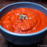 Blue bowl full of red tomato sauce